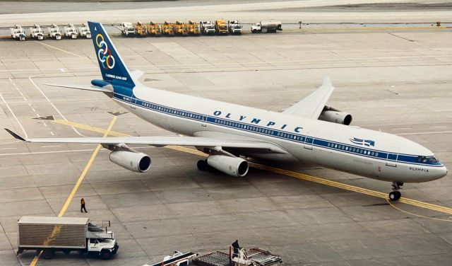 Airbus A340-300 (SX-DFA) - edited version of an earlier post of an Olympic Airways A340-300 pulling onto gate at Terminal 1 at YYZ. Unfortunately this spot no longer exists!