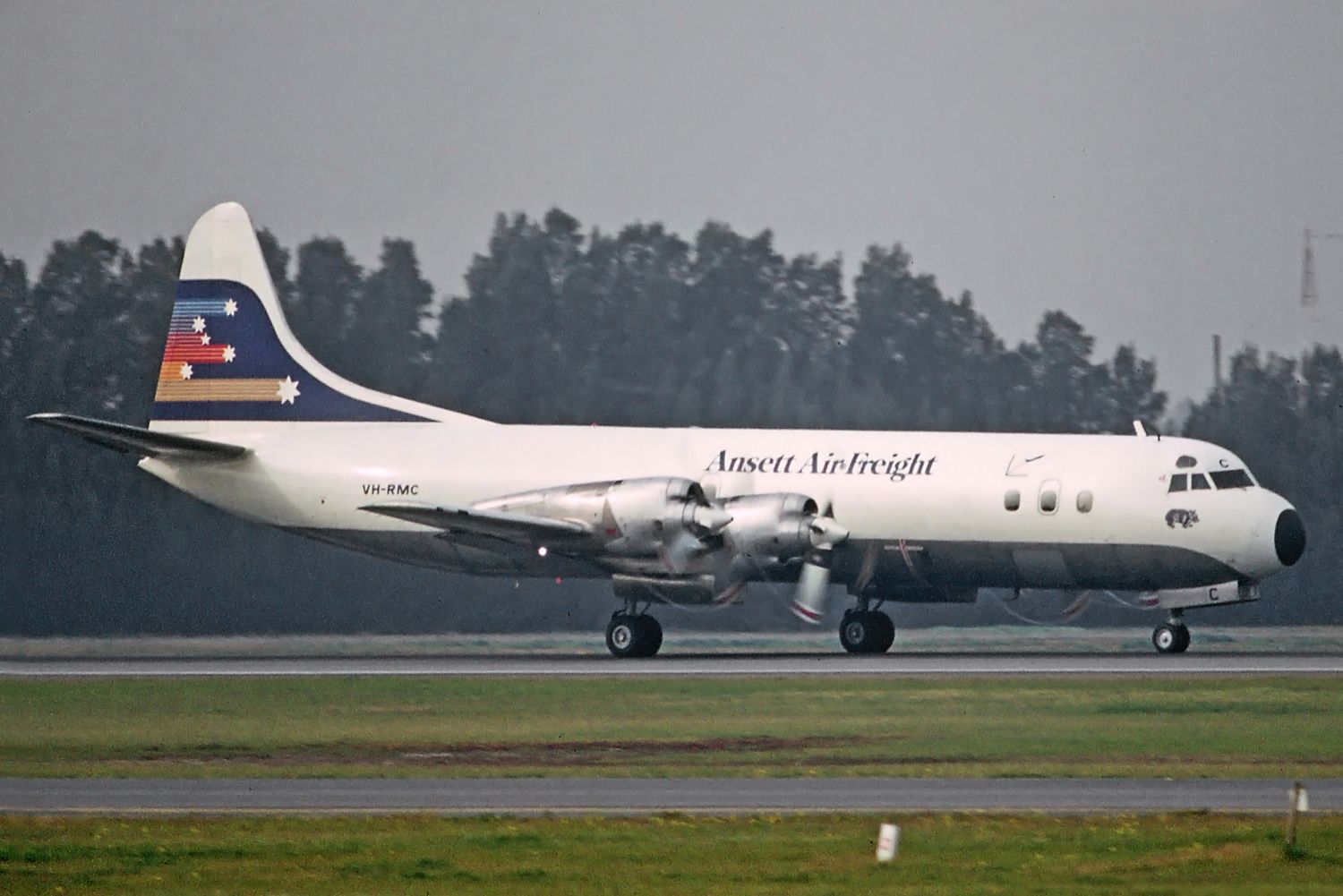 Lockheed L-188 Electra (VH-RMC) - Adelaide, South Australia, June 23, 1983. Ansett Freight Electra rolling on runway 23 on a daylight flight with prop tip vortices forming in the damp air.