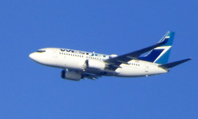 Boeing 737-700 (C-FTWJ) - Shown here is an WestJet Air Boeing 737-700 a few minutes until landing in the Autumn of 2016.