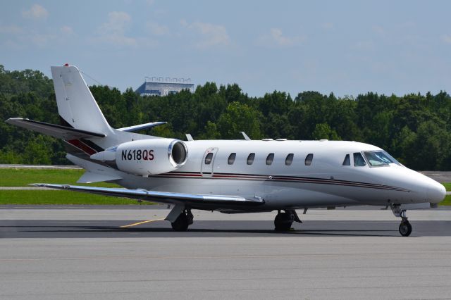 Cessna Citation Excel/XLS (N618QS) - NETJETS "Exec Jet" with the Charlotte Motor Speedway in the background at KJQF - 8/6/18