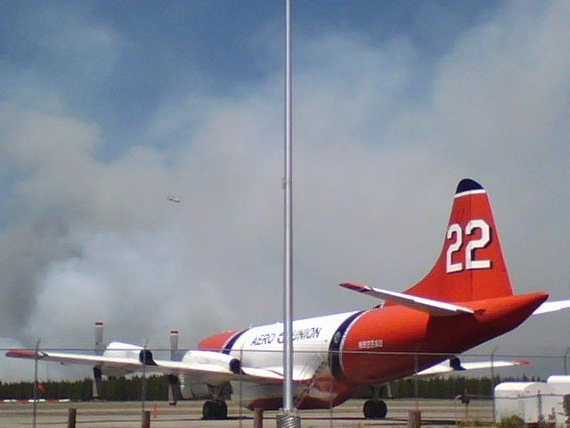 Lockheed P-3 Orion — - Tanker 22 watching 2007 fires on ramp at KWYS