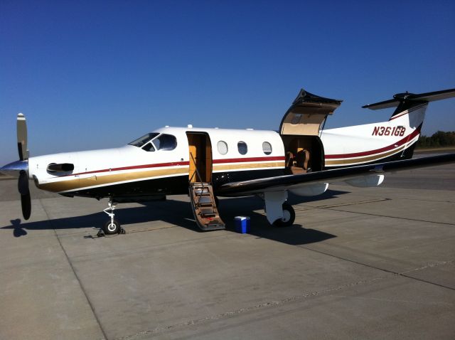 Pilatus PC-12 (N361GB) - This Pilatus PC-12 arrived and parked on the ramp in front of Tate Aviation and stayed until the American MD-82 Landed behind it.