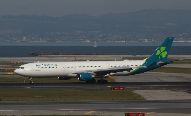 Airbus A330-300 (EI-EIM) - SFO - Feb 20, 2023 mid afternoon arrival on 28R A330-300 slowing down for the turn to the Terminal. I was up in the Tram way at one of the stations, I had forgotten Aer Lingus was enroute, good thing I stopped at this view point or I may have missed this.