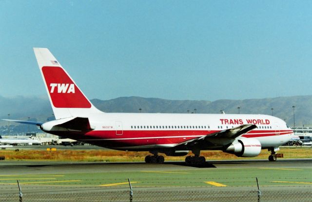 BOEING 767-200 (N608TW) - KSFO Millbrae Ave Airpark Aug 1996 shows TWA 767-200 pointed towards JFK on Runway 1R holding for ATC departure clearance. One thing nice about SFO and the 28LR crossing runway traffic was many jets had to sit here and wait several minutes sometimes for landing traffic. The lines of airliners could reach up to 15 jets waiting for 1R sometimes from EMB-110s to 747s. Millbrae Airpark was closed 9/11/2001.I eventually got an 8ft ladder in the back of my pickup truck as a 6ft ladder wasn't high enough as the fence was always there. Videos from here are on my YT page, search MarsAveSo.