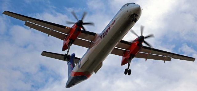 de Havilland Dash 8-400 (N437QX) - QXEs Boise State Broncos collegiate livery Dash 8 (N437QX) passes my position between runways 16L and 16R in the last few seconds of its approach to KRNOs 16L.