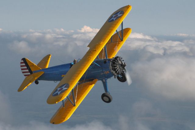 Boeing PT-17 Kaydet (N234X) - The Commemorative Air Force Heart of America Wing's Stearman biplane in a broken sky over New Century Aircenter.