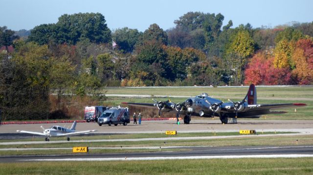 Boeing B-17 Flying Fortress (N5017N) - Making a tour stop courtesy of the Experimental Aircraft Association is this 1945 Lockheed World War II bomber "Aluminum Overcast" while a 1979 Piper Cherokee taxi to parking in the Autumn of 2019.