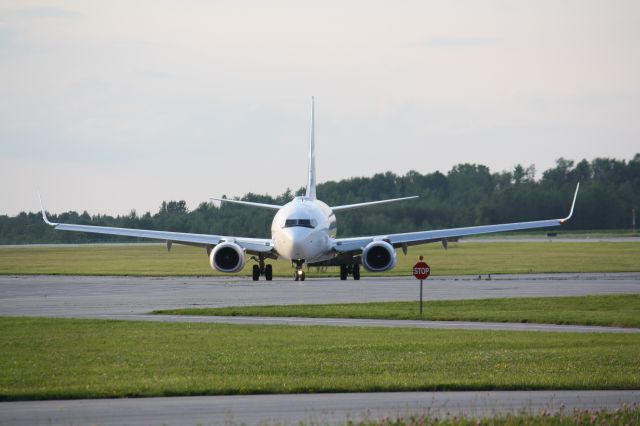 Boeing 737-700 (C-GWSU) - Westjet turning on taxiway for terminal,London International Airport,CYXU