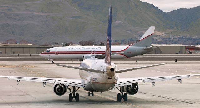 Embraer 175 (N110SY) - Waiting in the alley as a Kalitta Charters II B734 (N732CK), just arrived from Phoenix, taxies past on Alpha.