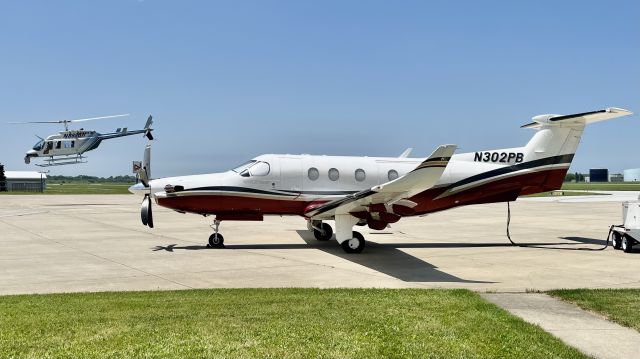 Pilatus PC-12 (N302PB) - N302PB, a 1999 Pilatus PC-12/45, being photobombed by a Bell 206L LongRanger III (N899BH). 6/14/22. 