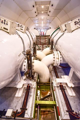 Boeing 747-400 (N744ST) - Global Super tanker interior showing the dispersal system. The 4 pipes exiting downward are the dispersal pipes and can empty the system of 19,500 galllons of retardant in 13 seconds.  The aft tanks are pressurized with air.  The entire system is palletized and can be removed in under 5 hours.