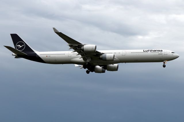 Airbus A340-600 (D-AIHI) - 'Lufthansa 8 Papa' arriving from Munich against stormy skies. Plane is named 'Mönchengladbach' after the city in western Germany near Düsseldorf.