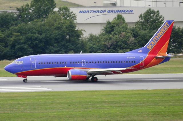 BOEING 737-300 (N387SW) - Seen at KBWI on 7/11/2009, this aircraft was involved in an explosive decompression incident two days later, on 7/13/2009.  A football-sized hole opened up just in front of the vertical stabilizer.  It was operating as WN2294 from KBNA to KBWI, and made an emergency landing in KCRW.  No injuries. (it was dark & overcast that day, so the photo is average)