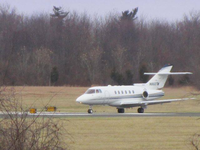 N860TM — - Beginning of the roll down the departing runway this Raytheon Hawker 800br /is shown here in the Winter of 2014.