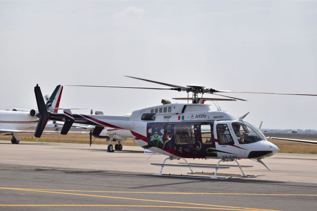 Bell 407 (XA-SAV) - Bell 407 XA-SAV MSN 53936 of Jetlife-ASESA. VIP configured helicopter with special local art expression livery on display during the open day in trade show "FAMEX 2019" at Santa Lucia AB (04/2019).
