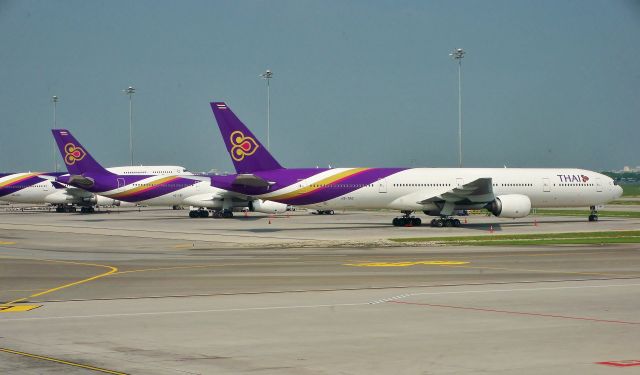 BOEING 777-300 (HS-TKE) - Thai Airways 777-3D7 HS-TKE leading the lineup next to A330-343 HS-TBF and 747-4D7 HS-TGF at Bangkok (BKK) on Oct 14, 2014.