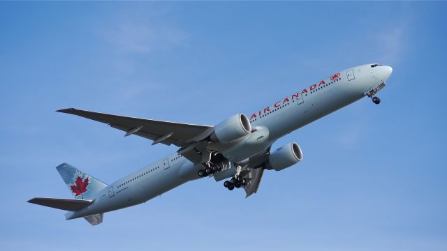 BOEING 777-300 (C-FNNU) - ACA7054 climbs from Rwy 16R beginning its delivery flight to KVCV on 12/19/13. (LN:1161 cn 43249).