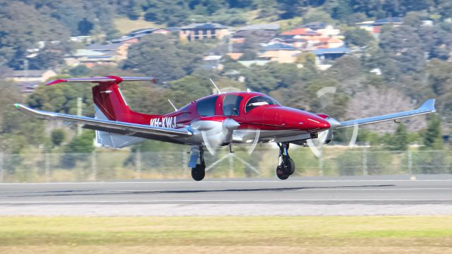 Diamond DA-62 (VH-XWJ) - VH-XWJ Departing Shellharbour airport with that beautiful red paint shining.