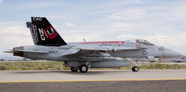 16-6434 — - A pair of first-appearance photos for FAs gallery.br /The CAG bird of the VFA-14 "Tophatters" ("The Oldest And The Boldest"), an F-18E Super Hornet, is captured here for its first-time post in the gallery as it taxies along NAS Fallons taxiway Alpha. This Superbug, assigned to USS John C. Stennis (CVN-74) when at sea and home ported at NAS Lemoore, was part of a massive midafternoon training exercise launch.br /This day of spotting at Fallon will always be a memorable one for me. The air temperature at this moment was 103 degrees. Standing in the open and being bathed in the hot exhaust from 30+ passing Navy jets meant the temperature at this location was well above 103.