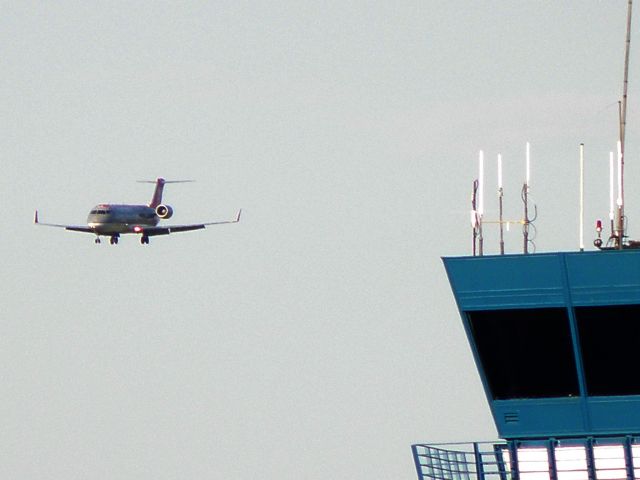 Canadair Regional Jet CRJ-200 (N8747B) - Flagship 5891 (Pinnacle Air N8747B) from Detroit (KDTW) gets a birds-eye view of the tower at Lexington (KLEX) moments before touching down...