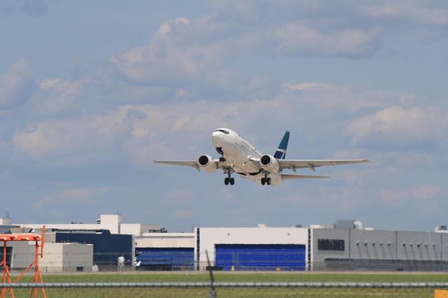 BOEING 737-600 (C-GEWJ) - WestJet leaving Montreal on runway 24L