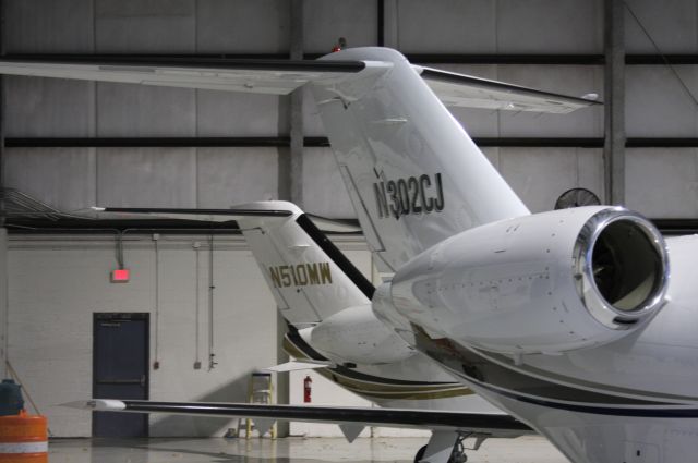 Cessna Citation CJ2+ (N302CJ) - HANGAR IN HUNTSVILLE, AL CESSNA CJ2+ AND MUSTANG IN THE BACKGROUND.