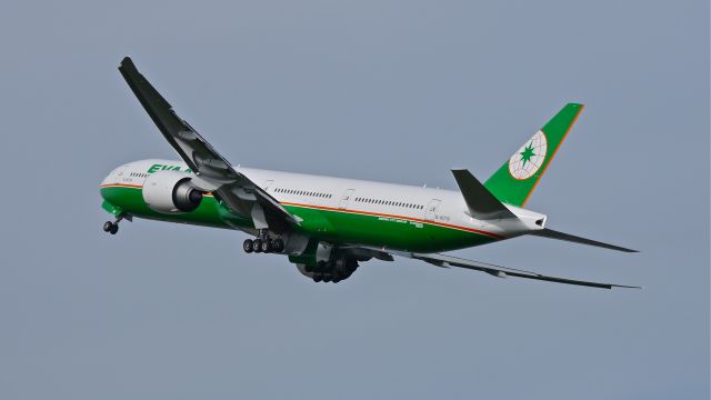 BOEING 777-300 (B-16719) - EVA773 does a wing wave as it climbs from Rwy 34L to begin its delivery flight to RCTP / TPE on 5/21/14. (LN:1202 / cn 42103).