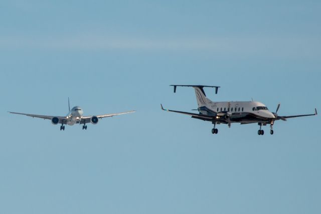 BOEING 777-300ER (C-FIVQ) - The B1900D heads for Runway 26, while the Boeing is right behind for 29.