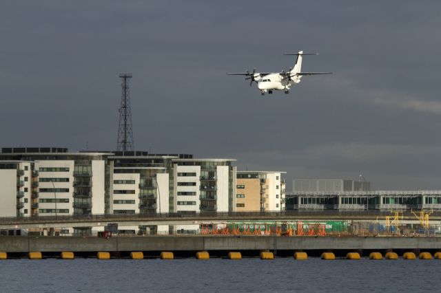 — — - Dornier 328, landing at London City Airport.