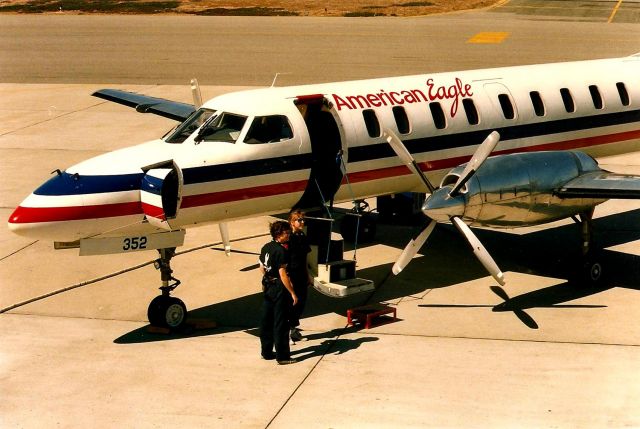 Fairchild Dornier SA-227DC Metro (N352AE) - Monterey, CA  June 1988 shows an American Eagle awaiting passengers as the ground crew is all set to assist boarding. This photo taken before the Obs deck was glassed off and forever ruining a great Obs deck for photos.