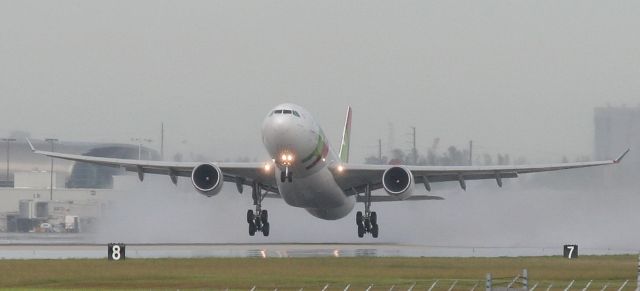 Airbus A330-200 — - Check out our aviation videos with 100% authentic and non-leveled sound! a rel=nofollow href=http://youtube.com/ilikeriohttps://youtube.com/ilikerio/abr /br /TAP A330-200 lifting off of a wet runway 27 at KMIA.