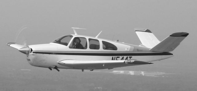 Beechcraft 35 Bonanza (N544T) - Saratoga 5B2 in background