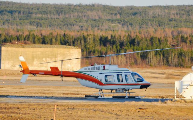 Bell JetRanger (C-FLIA) - This aircraft sits on the Universal Helicopters ramp at Gander Airport. In the background between runways are bunkers which are remnants of WWll.