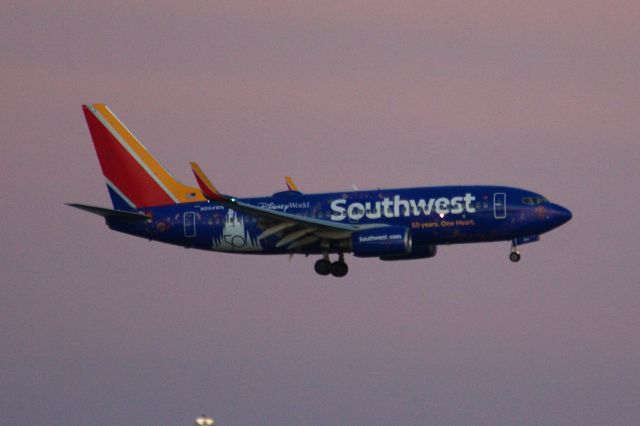 Boeing 737-700 (N954WN) - Southwest's new special color scheme - Walt Disney 50 Years arriving to Boston Logan at dusk on 10/12/21. 