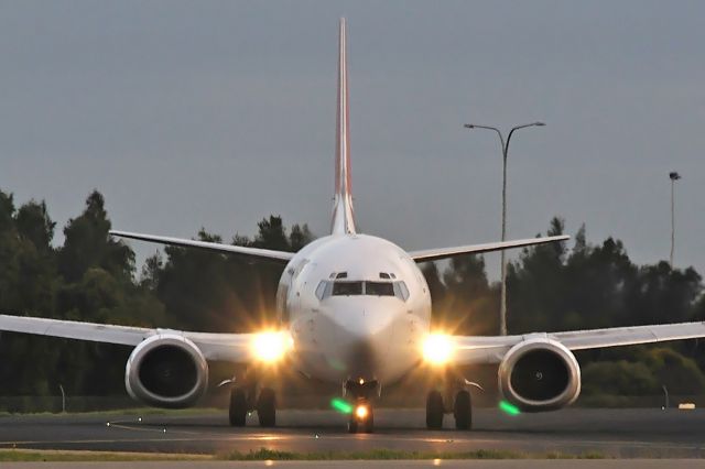 BOEING 737-400 (VH-TJT) - The sun wasn't up as this taxied on Foxtrot 6 for Rw 05 Adelaide, South Australia, August 28, 2009.