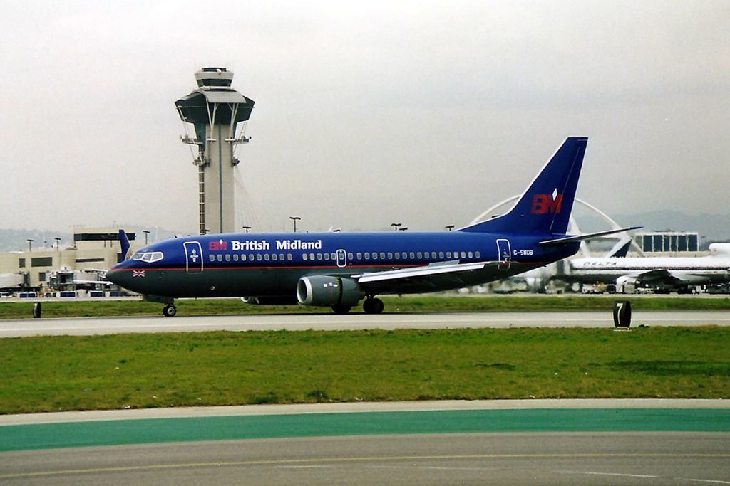 BOEING 737-300 (G-SMDB) - KLAX - rare photo of a British Midland 737 300 at LAX - This jet landed 25 L and turned left towards Cargo. It stopped for 5 minutes then rolled to 25 L for a departure. Total time on the ground 15 minutes. Later I learned this was a test flight from Seattle before delivery.