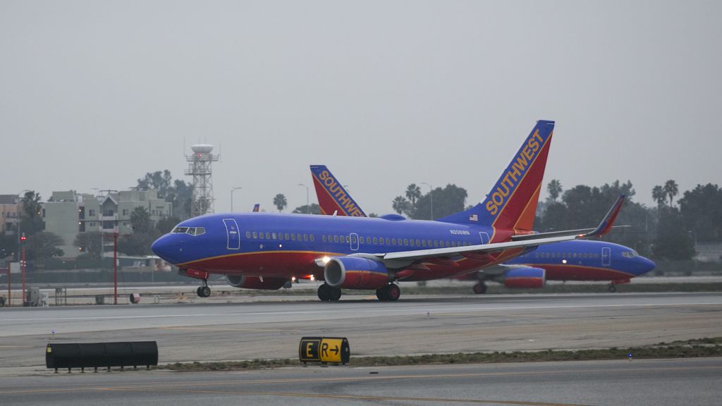 Boeing 737-700 (N206WN) - Coming and going at LAX. The plane in the back has just landed and is turning onto taxiway Yankee at LAX. 11 Dec 2014