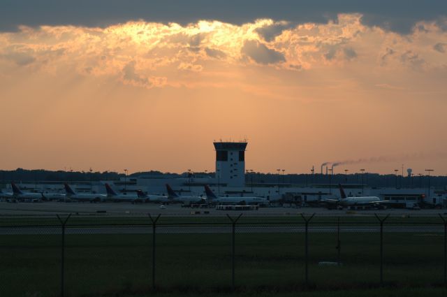 — — - a sunset picture of KCVG with a full ramp