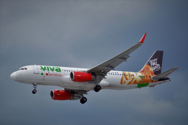 Airbus A320 (XA-VAX) - Airbus A320-232 XA-VAX MSN 8024 of VivaAerobus whit "TECATE PAL NORTE 2020" livery is on approach to Mexico City International Airport (08/2021).