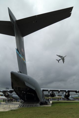 — — - The Boeing C-17 Globemaster Earth bound as an A380-800 gets to play.