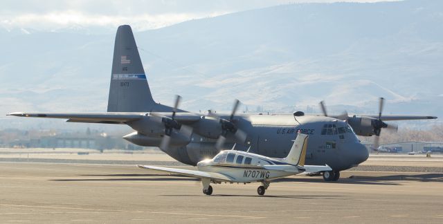 Beechcraft Bonanza (33) (N707WG) - A Nevada Air Guard "High Rollers" C-130 Hercules (79-0473) makes a nice background as a small Beech (N707WG) taxies past it.  Both aircraft were participating in an aircraft parade at Reno-Tahoe International. This is the first appearance in FAs photo gallery for N707WG.   