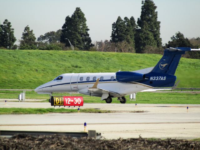 Embraer Phenom 300 (N337AS) - Holding short RWY 30