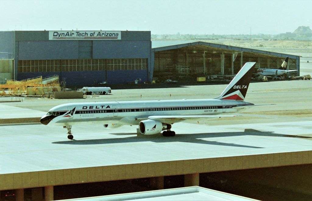 Boeing 757-200 (N667DN) - KPHX - my 1st trip to Phoenix AZ USA in July 1995 for the Airliners Intl airline collectible show. I drove from San Jose and stopped at MHV-Mojave and IGM-Kingman for airliner pics enroute and IFP LAughlin.....all with no Air conditioning. It was 115 in Laughlin the 1st night! This photo at PHX was the Friday before AI '95 weekend and friends were flying in from SJC and I was picking them up and take them over to the Camelback Resort, but I arrived early for jet pics. It was already over 100 degrees mid morning. My son was 11yrs at the time and we both loved it but had 5 1 gallon water jugs w/us to drink all day-- great jet action at PHX and the top floors of the different terminal parking garages were very helpful and this photo here is the "mid chute" between runways and great for photos AM or PM. The building on the background is long gone and SWA has the newer terminal gates here now - one can get here fill of SWA action in 1 hr. I also filmed hours of video from up here over the years also, C&P: https://www.youtube.com/watch?v=zW81hvRFpIM