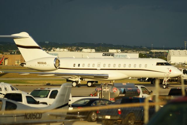 Bombardier Global Express (N806AS) - Parked, last sunlight of the day peeking through storm clouds