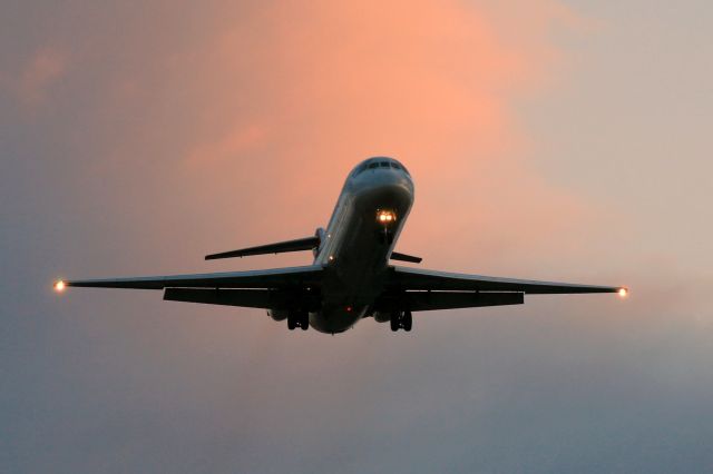 — — - Sunset approach of Northwest DC9-32