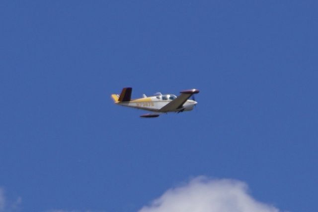 Beechcraft 35 Bonanza (N7387B) - Taken from the base of Devils Tower National Monument in Wyoming. 