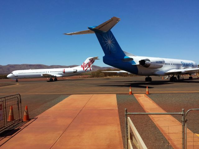 — — - The old and the new, Skywest Fokker 100 just landed and Ex Skywest Fokker 100, VH FSQ, preparing to leave West Angelas airport.