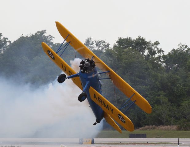 — — - John Mohr does his famous low pass in a stock Stearman during the 2013 Sun 'n Fun fly in at Lakeland, Florida.