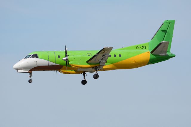 Saab 340 (VH-ZXS) - On short finals for runway 05. Still painted in the livery of its previous operator, Thailands Happy Airlines. Thursday, 8th May 2014.