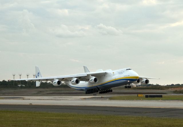 Antonov An-225 Mriya (UR-82060) - Just lifting off runway 36 Center at Charlotte, North Carolina USA. Open in "full" and count the wheels...23 ...24... Nothing Photoshopped to make extra engines or alterations, this is the real thing. It was extremely popular with the airport personnel, everyone crowded out to get a glimpse of the big plane roar down the runway for takeoff. It seemed to rotate at about the same place as bigger Airbuss and Boeings. The climb out was strong and it went out of sight fairly quickly. The six engines made a slight trail of dark smoke, not as clean running as our Pratts, Rolls and GE engines. This photo was taken at sunset, 4 October 2010.